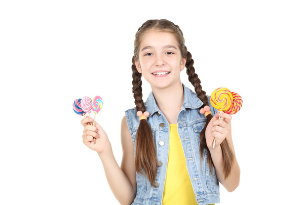 Beautiful young girl with sweet lollipops on white background - Valokuva, kuva