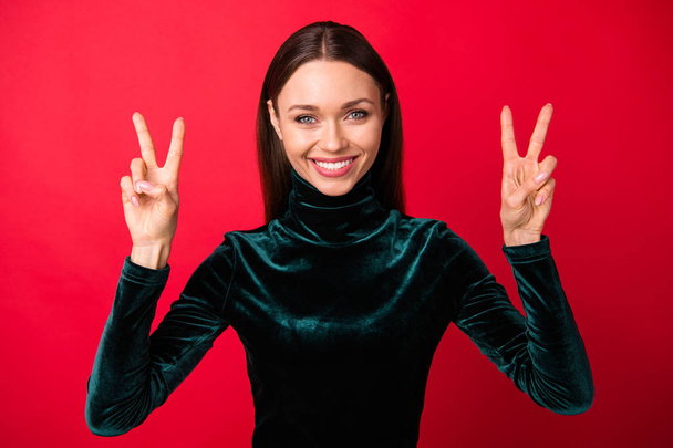 Portrait of pretty youth make v-signs feel content isolated over red background - Foto, imagen