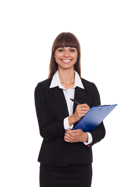 Businesswoman writing on clipboard - Photo, image