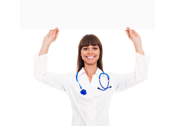 Doctor woman with stethoscope hold blank billboard - Fotoğraf, Görsel
