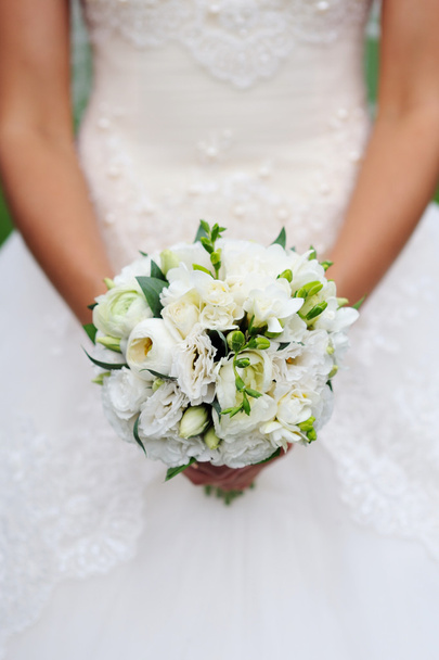 Beautiful white wedding bouquet in hand of bride - 写真・画像