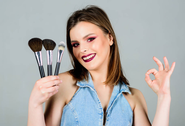 Cosmetology and beauty. Lipstick and eyeshadow. sensual woman with long hair, style. fashion makeup visage. sexuality. skincare cosmetics. sexy woman with professional make up brush - Photo, Image