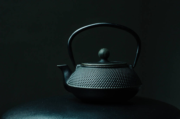 Black textured cast iron kettle  - Fotó, kép
