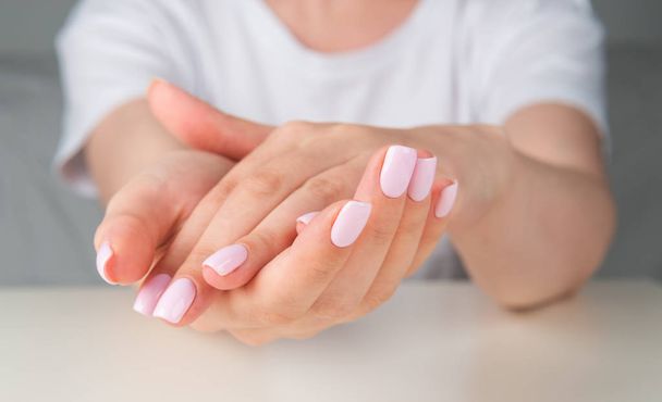  hands with light pink nail design - Photo, image