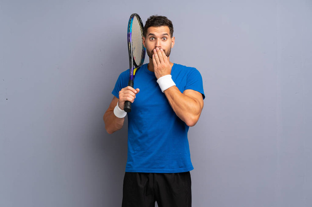 Handsome young tennis player man with surprise facial expression - Photo, Image