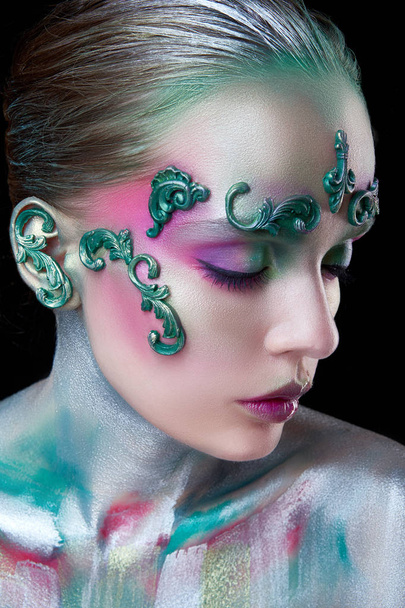 young beautiful girl with creative make-up of green and purple flowers - Photo, Image