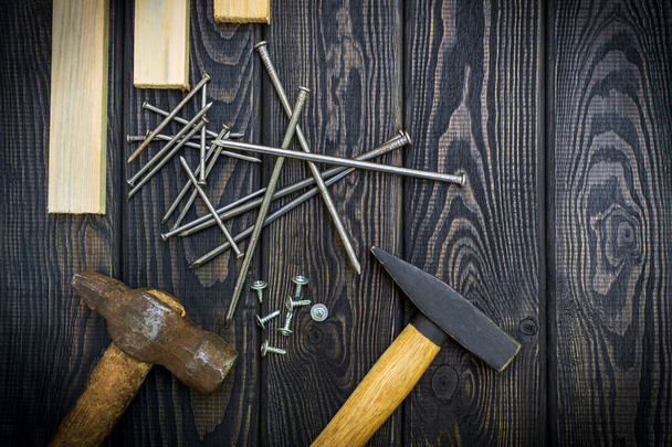 Tools for carpentry and accessories on a black wood background. - Фото, зображення