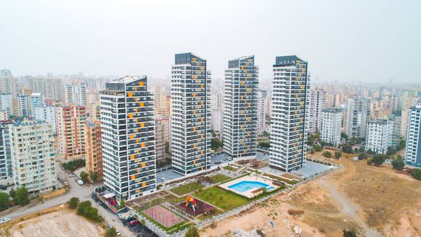 New multi-storey residential building apartment houses aerial view with swimming pool, basketball court and children playground. Mortgage background concept image. - Photo, Image