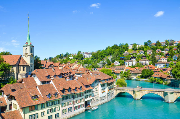 Bern, the capital of Switzerland, with dominant Nydegg Church and historical center located along turquoise Aare River. Bridge over Aare. Tourist destination, local attraction. Swiss city - Photo, Image