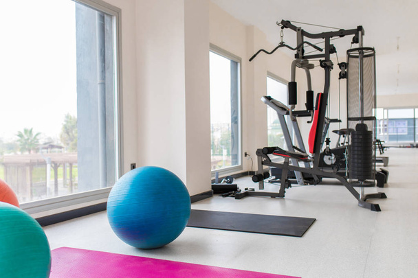 Colorful pilates balls and exercise sports equipments indoor concept image background. Gym interior. - Valokuva, kuva