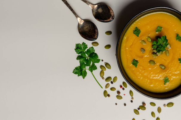 Pumpkin soup with pumpkin seeds on white background. top view - Photo, Image