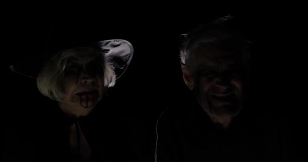 Elderly man and woman in Halloween costumes. Witch and zombie - Footage, Video
