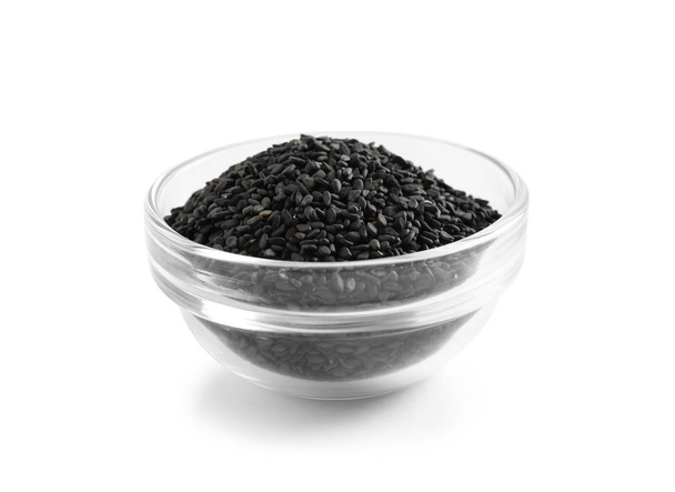 Black sesame seeds in bowl on white background. Delicious sauce condiment - Фото, изображение
