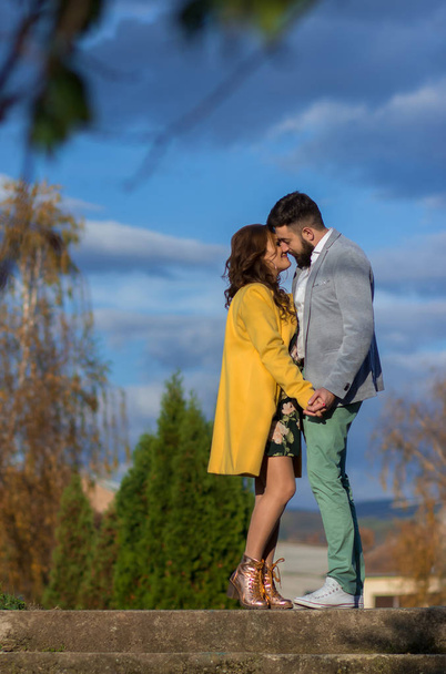 Outdoors photo, beautiful, young couple being affectionate with each other - Fotografie, Obrázek