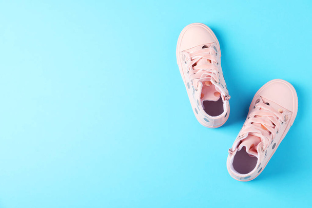 Pair of stylish child shoes on blue background, flat lay. Space for text - Fotoğraf, Görsel
