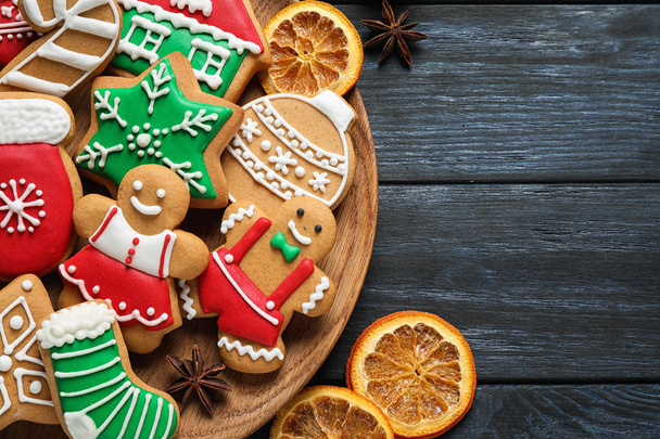 Flat lay composition with tasty homemade Christmas cookies on dark blue wooden table - Foto, Imagem