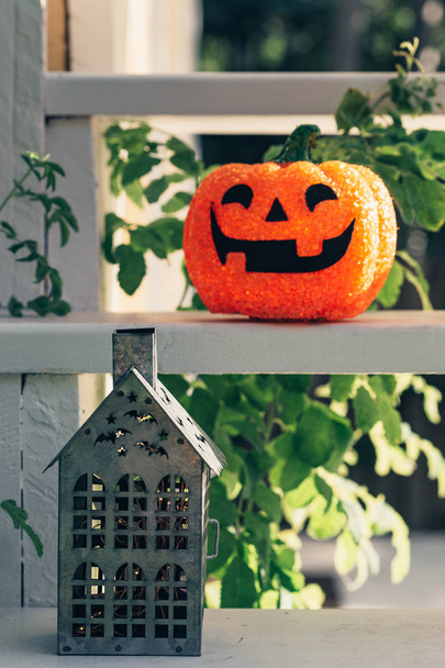 Vintage old-fashioned retro Halloween outdoor decorations. Garden Halloween decor with pumpkin, metal house. - Photo, Image