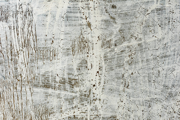 Texture of a concrete wall with cracks and scratches which can be used as a background - Fotó, kép