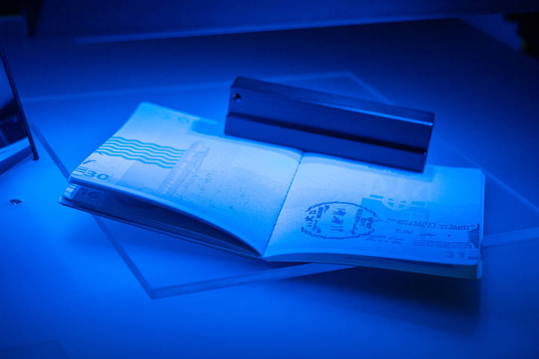 Vérification du passeport pour la fraude dans les UV et une autre lumière, detecti
 - Photo, image