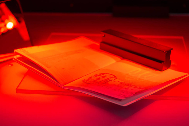 Checking the passport for fraud in UV and another light, detecti - 写真・画像