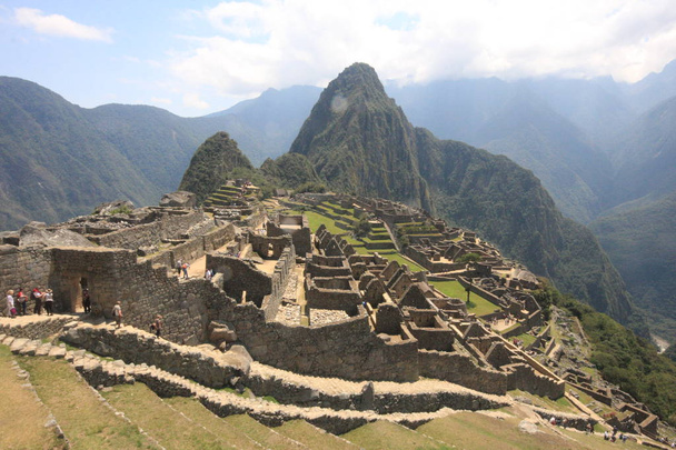 Machu Picchu Incan citadel in the Andes Mountains in Peru - Photo, Image