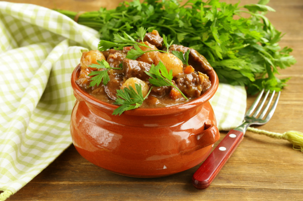 Beef stew with vegetables and herbs in a clay pot - comfort food - Photo, Image