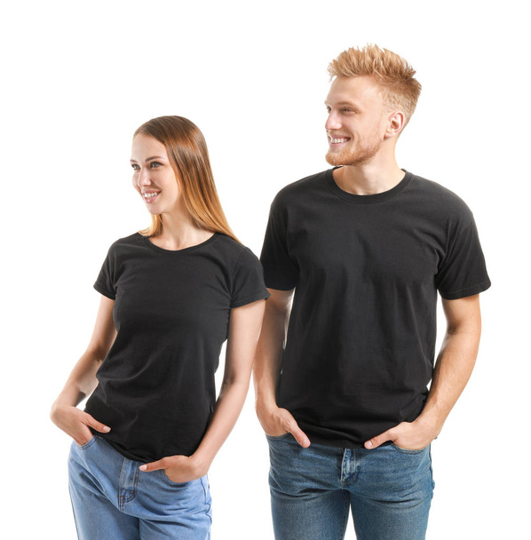 Couple in stylish t-shirts on white background - Foto, Imagen