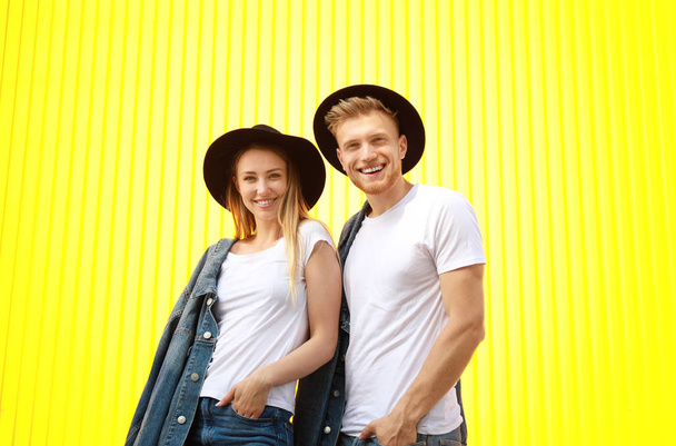Man and woman in stylish t-shirts on color background - Photo, Image