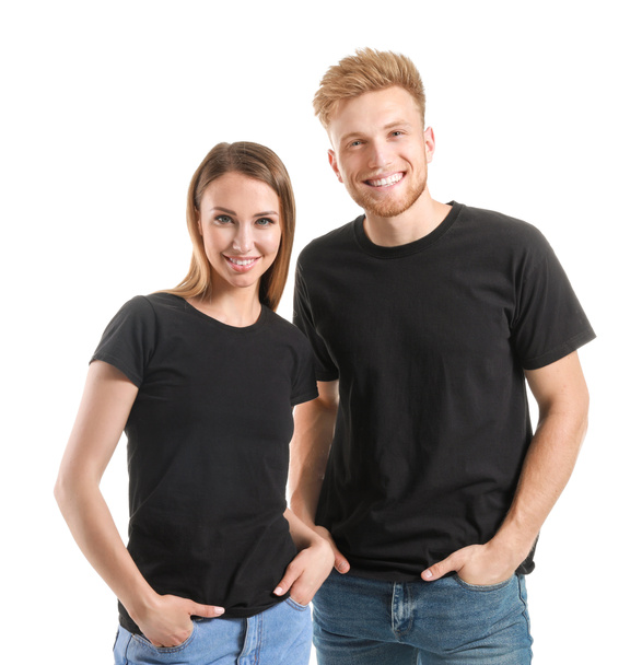 Ζευγάρι σε κομψά μπλουζάκια σε λευκό φόντο - Φωτογραφία, εικόνα