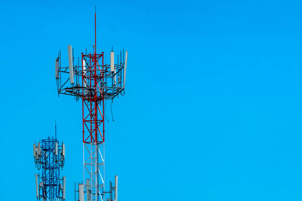 Telecommunication tower with blue sky and white clouds background. Antenna on blue sky. Radio and satellite pole. Communication technology. Telecommunication industry. Mobile or telecom 4g network. - Photo, Image