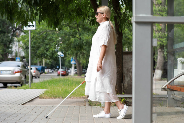Blind mature woman walking outdoors - Fotoğraf, Görsel