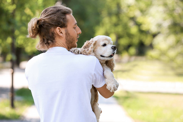 Male volunteer with cute dog outdoors - Photo, Image