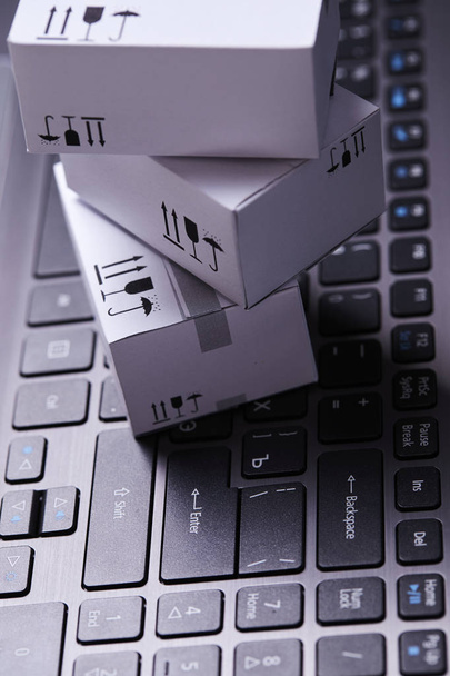 delivery packaging boxes on laptop keyboard  - Photo, Image
