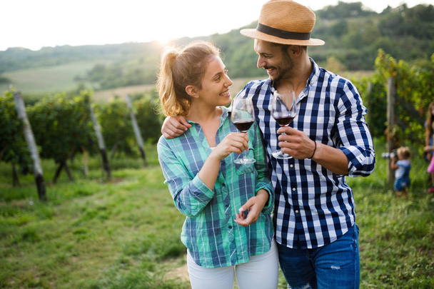 Couple in love working at winemaker vineyard and tasting wines - Fotografie, Obrázek