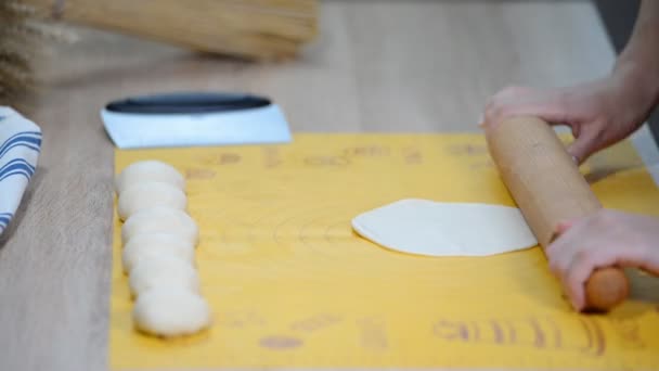 Женщина выкатывает тесто на деревянную доску. Шаг за шагом рецепт домашней лепешки
. - Кадры, видео