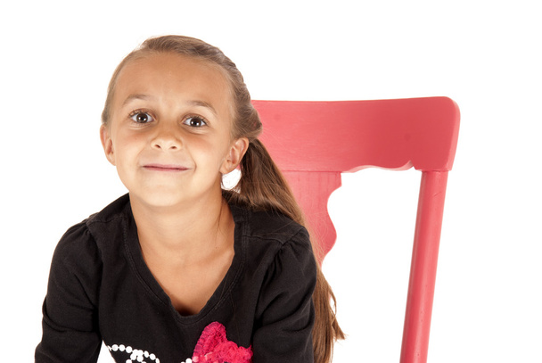 Girl in pink chair close up with a cheesy grin - Фото, изображение
