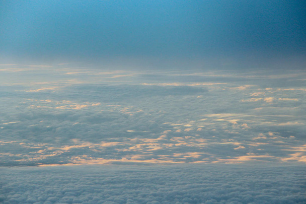 Piękny widok z okna samolotu w porannym słońcu nad chmurami - Zdjęcie, obraz