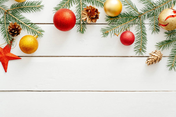 Рождественская композиция Граница рамки из рождественских украшений, красной звезды, золотых шариков, конусов на белом деревянном фоне. Плоская лежала, вид сверху, копировальное пространство. Рождество, Новый год, концепция зимних каникул
 - Фото, изображение