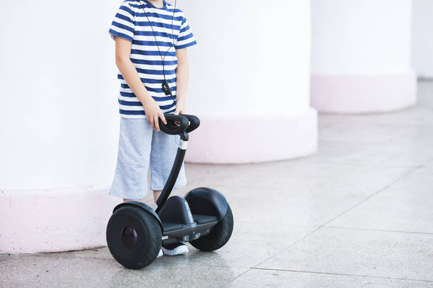 Cute little boy driving segway. Child skating on hyroboard. Boy driving hover. - Photo, Image