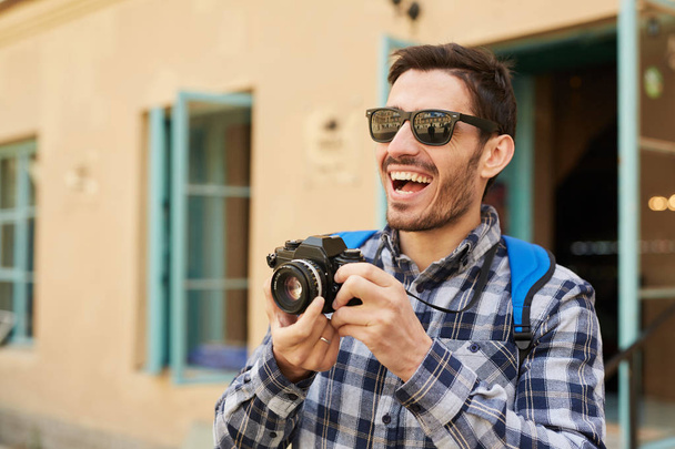 Retrato de cintura hacia arriba del joven turista feliz tomando fotos mientras viaja, espacio para copiar
 - Foto, Imagen