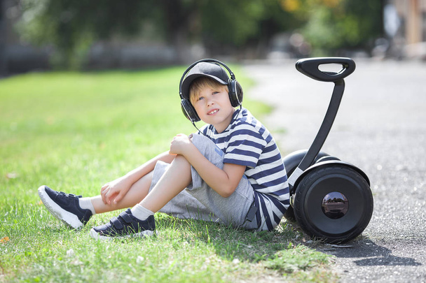 Cute little boy driving segway. Child skating on hyroboard. Boy driving hover. - Foto, Imagem