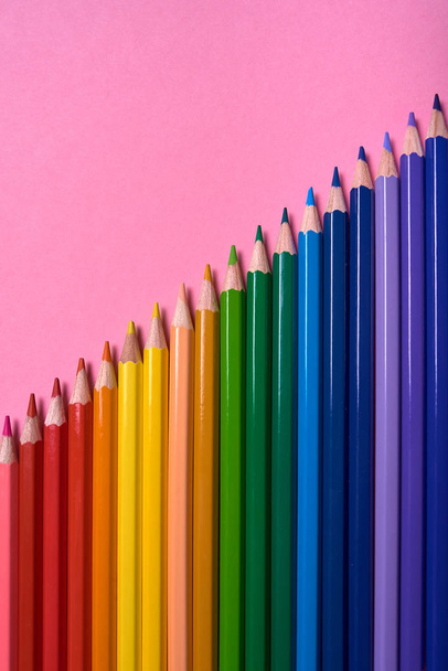 Color pencils on pink pastel background, close up. Set of colorf - Foto, Imagem