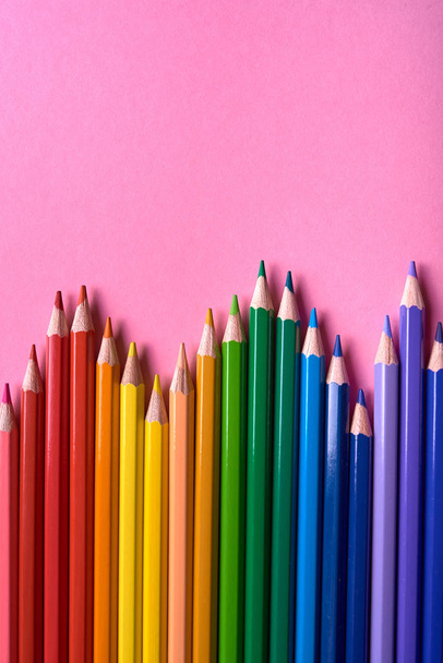 Color pencils on pink pastel background, close up. Set of colorf - Фото, изображение