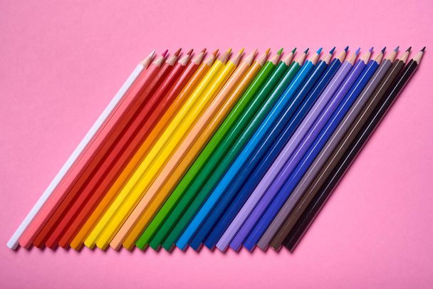 Color pencils on pink pastel background, close up. Set of colorf - Foto, imagen