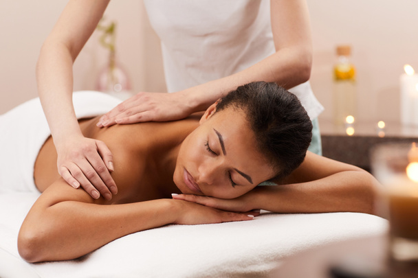 Portrait of blissful young woman enjoying massage in luxury SPA, copy space - Фото, зображення