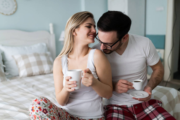 Romantic young couple having fun in bedroom together - Photo, image