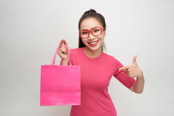 Joyful woman shopping packages pink color - Foto, imagen