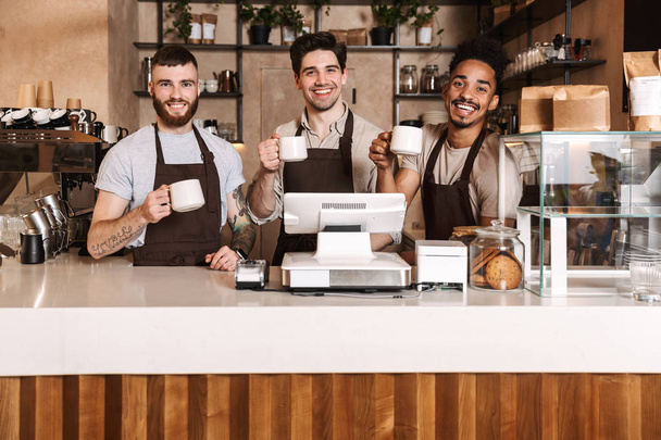 Happy coffee men colleagues in cafe bar working indoors. - Foto, Imagen