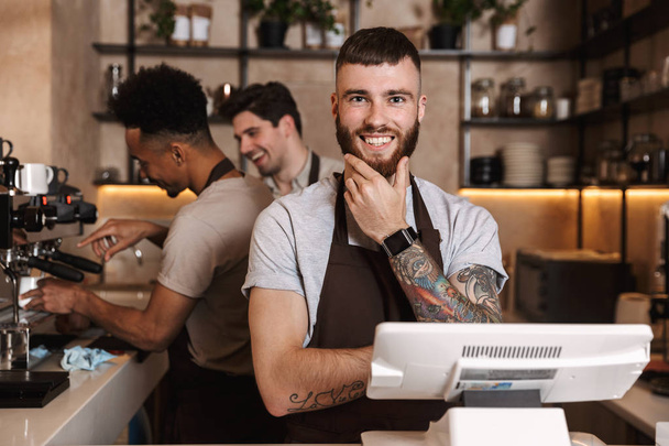 Happy coffee men colleagues in cafe bar working indoors. - Фото, изображение