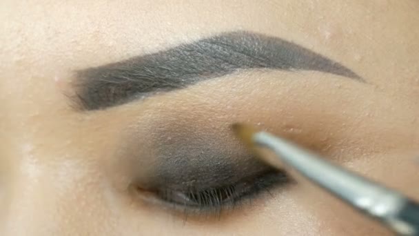 Profesyonel makyaj sanatçısı özel fırça ile Koreli kız Asyalı kadın göz makyajı yapar - Video, Çekim